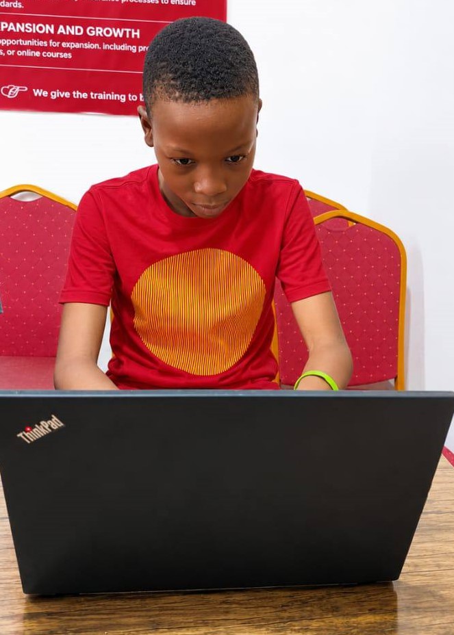 David Adekunle-Dare working on his laptop at GiiT